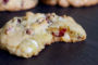 Cranberry and white chocolate chip cookie with a bite taken out of it
